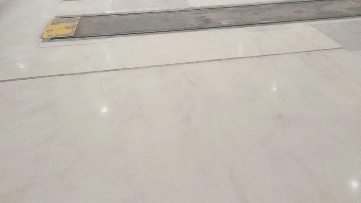 Existing workshop floor condition and completed grey epoxy coated zone